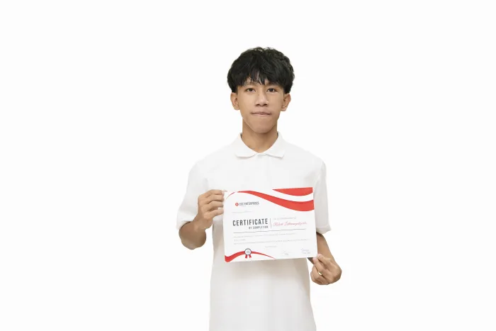 An ECC graduate holding their course completion certificate