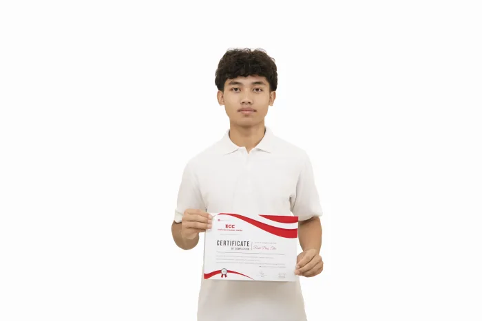 An ECC graduate holding their course completion certificate